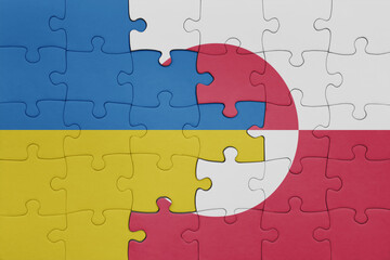puzzle with the colourful national flag of greenland and flag of ukraine.