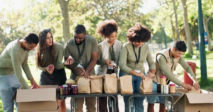 Volunteer, people and food donation packing in park for lunch, bags and community service with non profit. Teamwork, happy and project at NGO and social responsibility charity with groceries outdoor