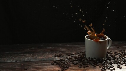 Super slow motion of falling ice dropping in to coffee cup and splashing with black separated...