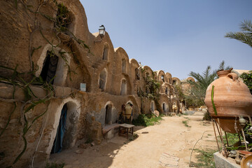 Traditional ancient multi-level earthen granaries with arched doorways in Ksar Ouled Brahim, also...
