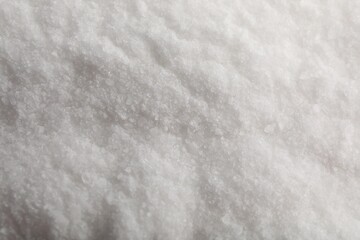 White natural salt as background, top view