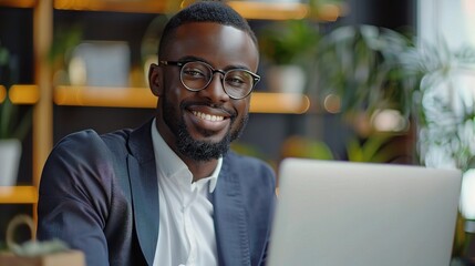 Obraz premium portrait of a happy businessman on a laptop in the office, focused on finance, budget reports