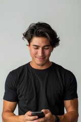 A man is smiling while holding a cell phone