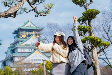 Travel, muslim travel, woman girl tourist Two Asian friends but different religions walking at...