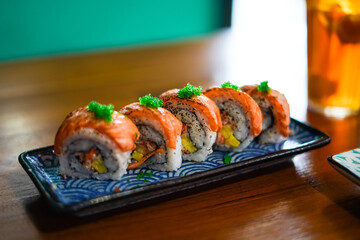 sushi roll topped wit salmon, Japanese traditional dishes, selective focus
