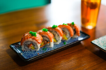 sushi roll topped wit salmon, Japanese traditional dishes, selective focus