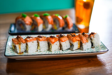 sushi roll topped wit salmon, Japanese traditional dishes, selective focus