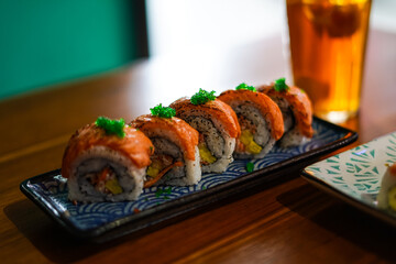 sushi roll topped wit salmon, Japanese traditional dishes, selective focus