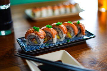sushi roll topped wit salmon, Japanese traditional dishes, selective focus