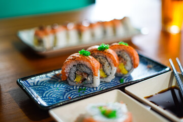sushi roll topped wit salmon, Japanese traditional dishes, selective focus