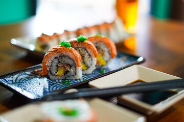 sushi roll topped wit salmon, Japanese traditional dishes, selective focus