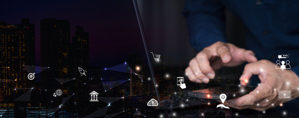 IoT Internet of Things, E-commerce concept. Man using mobile phone and laptop computer.