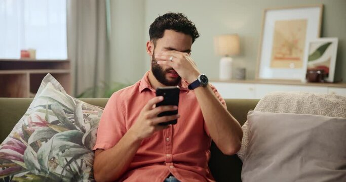 Home, stress and man with smartphone, frustrated and slow internet with social media, negative feedback and contact. Apartment, person and guy on couch, cellphone and bad news with glitch and mistake