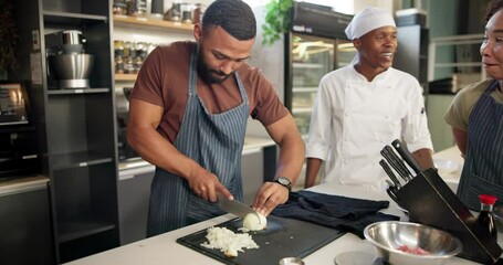 Chef, cooking class and onions in kitchen for learn, teacher and food for professional skills. Restaurant, cutting or culinary student with knife, vegetables jubilee and preparation for recipe