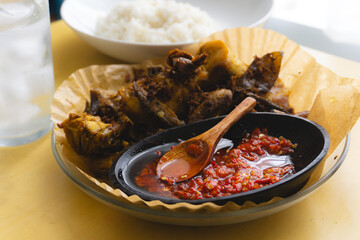 Sambal, Indonesian Traditional Chilli sauce, serve with traditional fried chicken with turmeric and steaming hot rice