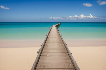 Long wooden bridge to sea at beautiful tropical beach