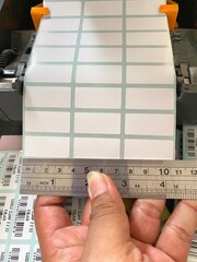 Someone is measuring print paper, which contains 3 coloumn. To prepare print product price.
