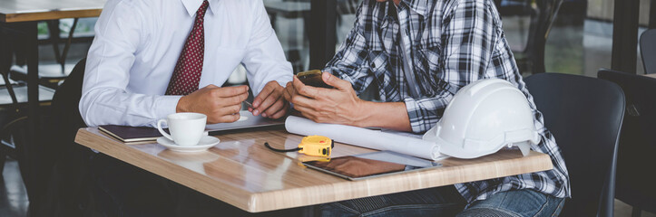Banner Contractor construction engineer meeting on architect table at construction site. Businessman engineer manager discuss talk together foreman team builder using measure tape with copy space