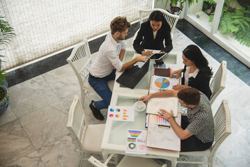 Top view business people meeting together at office desk in conference room. Team business meeting partnership planning brainstorming together. Team Collaborate group of partner company brainstorming