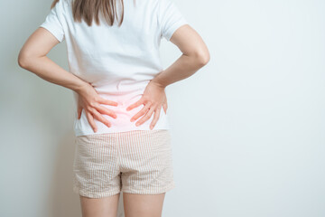 woman having back body ache during at home. adult female with muscle pain due to Piriformis...