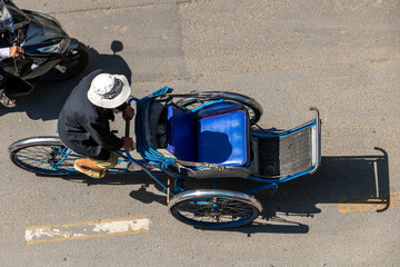 A man drives a tricycle for transport a passenger, Saigon, Vietnam