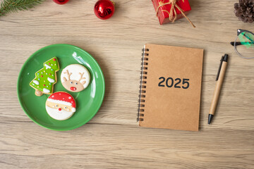 2025 notebook, black, Christmas cookies and pen on wood table, Top view and copy space. Xmas, Happy...