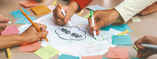 Professional startup group share creative marketing idea by using mind map. Young skilled business...