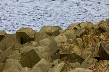Artificial breakwater wall of large rocks