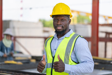 Engineer man with doing thumbs up gesture, Cheerful foreman worker on a construction site.