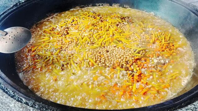 A man prepares plov or osh at the Central Asian Plov Centre in Tashkent, Uzbekistan