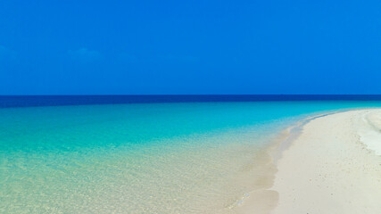 Nature of the beach and sea Summer with sunshine, sandy beaches, clear blue waters sparkling against the blue sky. On an island with good ecology and environment Background for summer vacation concept