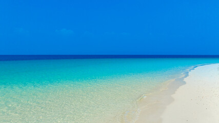 Nature of the beach and sea Summer with sunshine, sandy beaches, clear blue waters sparkling against the blue sky. On an island with good ecology and environment Background for summer vacation concept