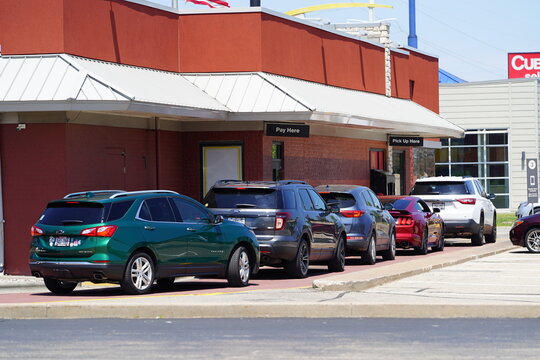 Customers in their vehicles lined up at McDonald's drive-thru to order food.