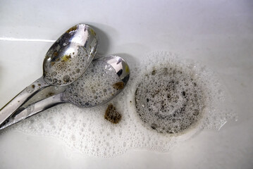 Washing spoons with soap