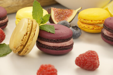 Vibrant scene of table filled with macaroons and fruits
