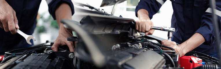 Mechanic are using the wrench to repair and maintenance auto engine at car repair shop,Car auto...