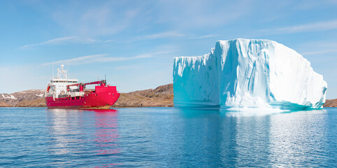 Arctic Ship leaving Tasiilaq after having unloaded at the docks in the harbour - Tasiilaq, Greenland