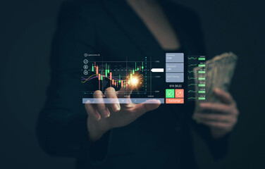 Businessman is holding money and selecting stocks. Investment concept. Stock trading. Stock trading. Investment planning. Stock market risk.