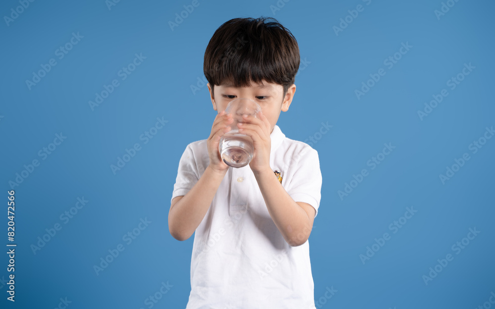 Wall mural portrait of asian boy posing on blue background