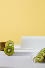 Abstract composition in minimal design with few empty podiums and fresh kiwis. Due to the high Vitamin C content, kiwis can help to support the immune system