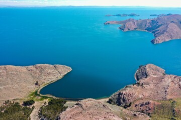 LAKE BAY WITH BLUE WATER AND SPRING MEADOWS