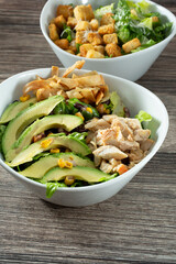 A view of a Southwestern chicken salad, and a Caesar salad.