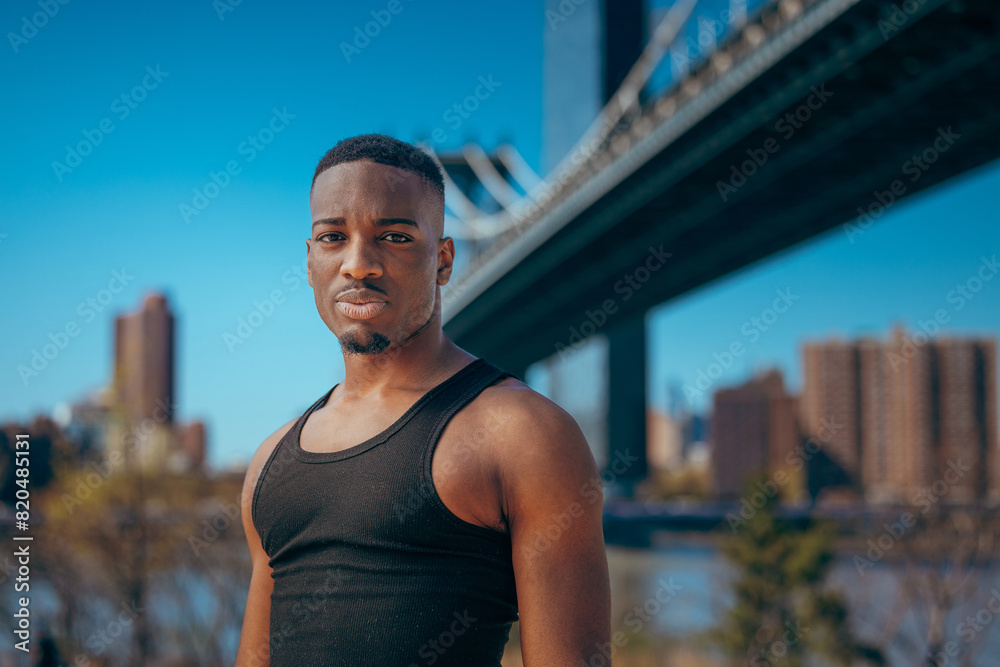 Wall mural A confident young man in a black tank top