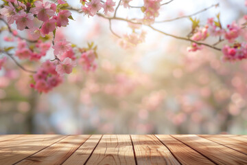 Naklejka na ściany i meble A wooden desk top with blurred background of skura tree with cherry blossom. Good for background