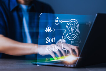 A man is typing on a laptop with a screen that says 