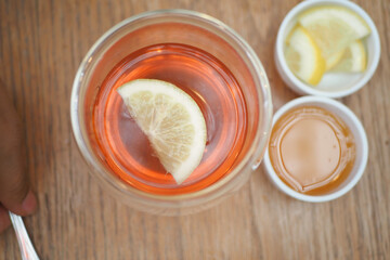 Top view of lemon tea pouring in a cup