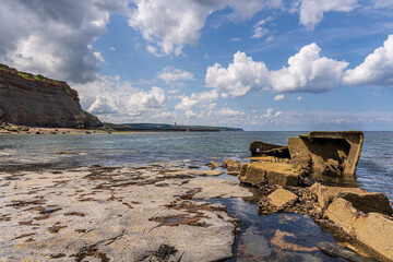 View from the North Sea coast at the East Cliff towards the lighthouses in Whitby