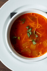 A top down view of a bowl of pasta e fagioli soup.