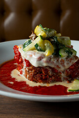 A closeup view of a plate of melanzane al forno.