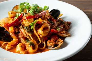 A closeup view of a plate of linguine alla bucaniera.